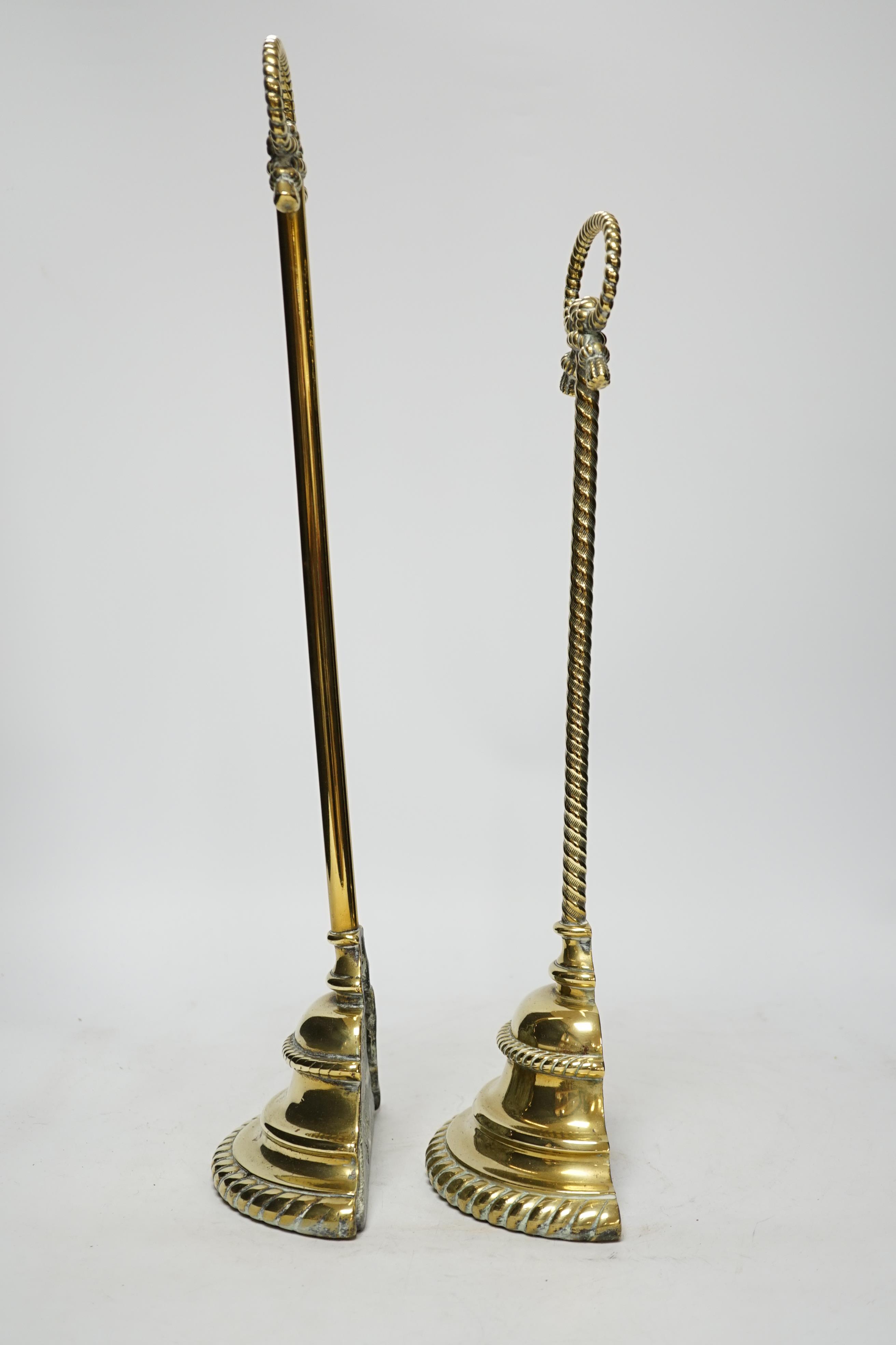 Two early 19th century cast brass door stops, with gadrooned edged plinths, tallest 50cm high
